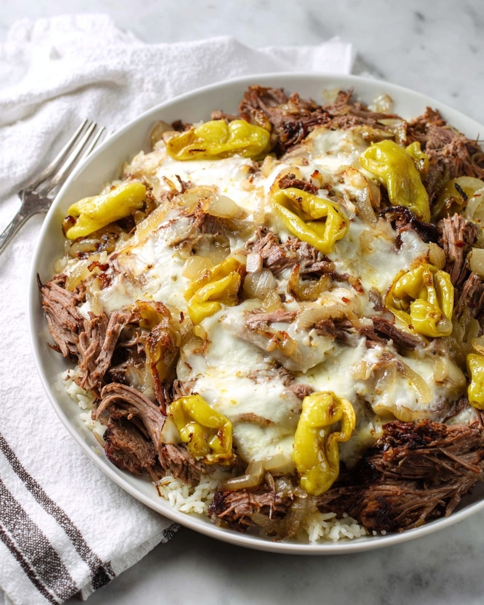 The dish shows a white plate full of shredded, dark brown cooked beef, arranged evenly in layers. On top of the beef, there is melted white cheese covering most of the surface, creating a creamy texture. Scattered between the beef are yellow, slightly wrinkled whole peppers, adding bright pops of color across the plate. Some cooked light brown onions are mixed with the beef and cheese, adding another texture and color layer. The plate rests on a white marbled surface with a white cloth that has thin dark stripes beside it. Photo taken with an iphone --ar 4:5 --v 7