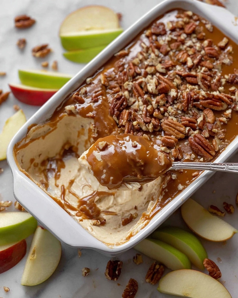 A white rectangular baking dish filled with one smooth, even layer of thick, glossy, dark caramel sauce that covers the entire surface. The dish rests on a white marbled texture, with a green apple and a red apple partially visible in the top right corner. The caramel layer looks rich and shiny with slight texture variations and edges touching the white dish walls. Photo taken with an iphone --ar 4:5 --v 7