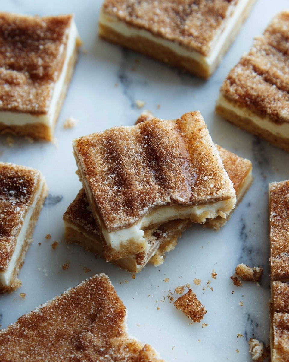 The image shows several square pieces of a layered dessert on a white marbled surface. Each piece has three layers: a bottom light brown layer with a slightly crumbly texture, a smooth creamy white middle layer, and a top layer coated with a mixture of coarse sugar and cinnamon giving it a grainy, brownish look. The top layer looks slightly cracked and uneven, with one piece showing a bite taken out of it. Crumbs and small broken pieces are scattered around the squares, adding to the rustic feel. photo taken with an iphone --ar 4:5 --v 7