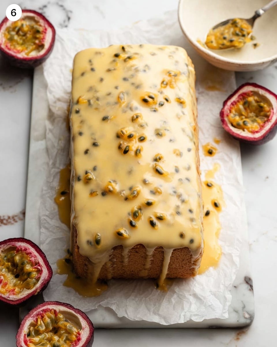 A rectangular cake covered in smooth, light yellow glaze with many small black passion fruit seeds visible on top, creating a speckled effect. The cake is placed on white parchment paper on a white marbled surface. Around the cake are cut and whole passion fruits, showing the bright yellow-orange pulp and black seeds inside. To the right side of the cake, a white bowl with a spoon rests, filled with more passion fruit pulp. The glaze gently drips off the edges of the cake creating a slightly soft look. Photo taken with an iphone --ar 4:5 --v 7