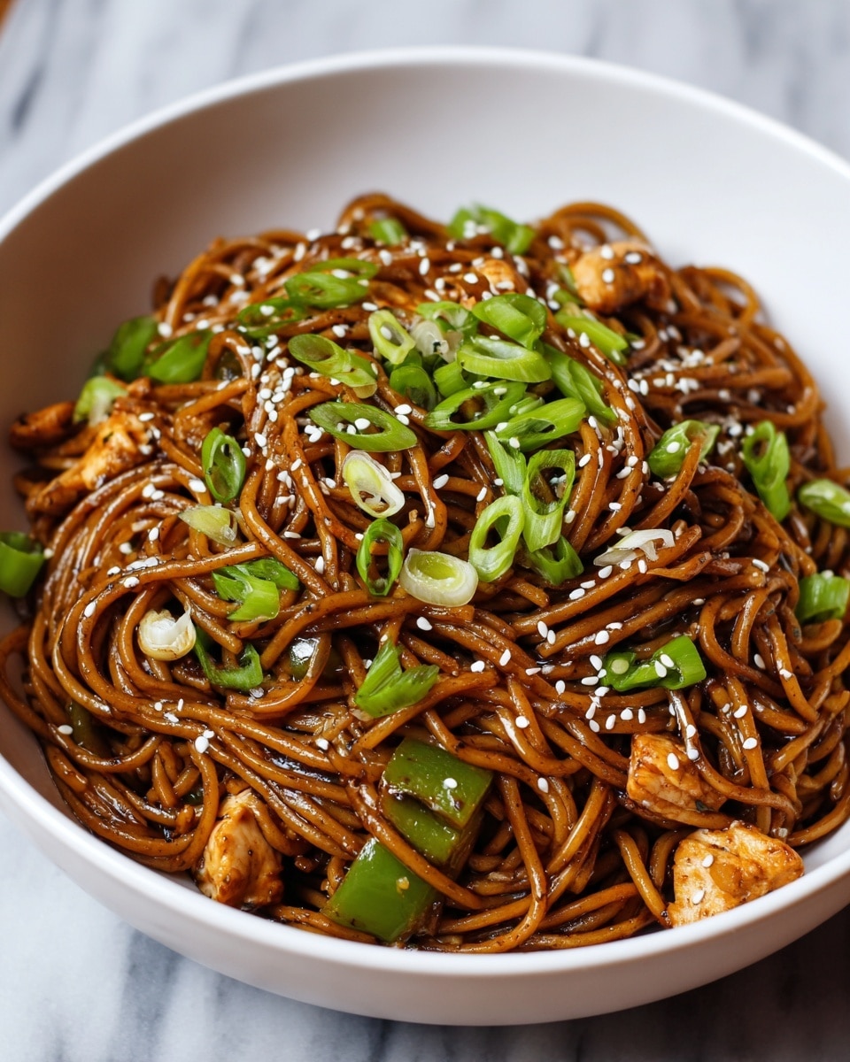 A white bowl filled with a pile of dark brown noodles coated in sauce, mixed evenly with small green bell pepper pieces and chunks of light brown chicken. The noodles are topped with bright green chopped spring onions and scattered white sesame seeds. The bowl sits on a white marbled surface with a blurred white cup in the background. photo taken with an iphone --ar 4:5 --v 7