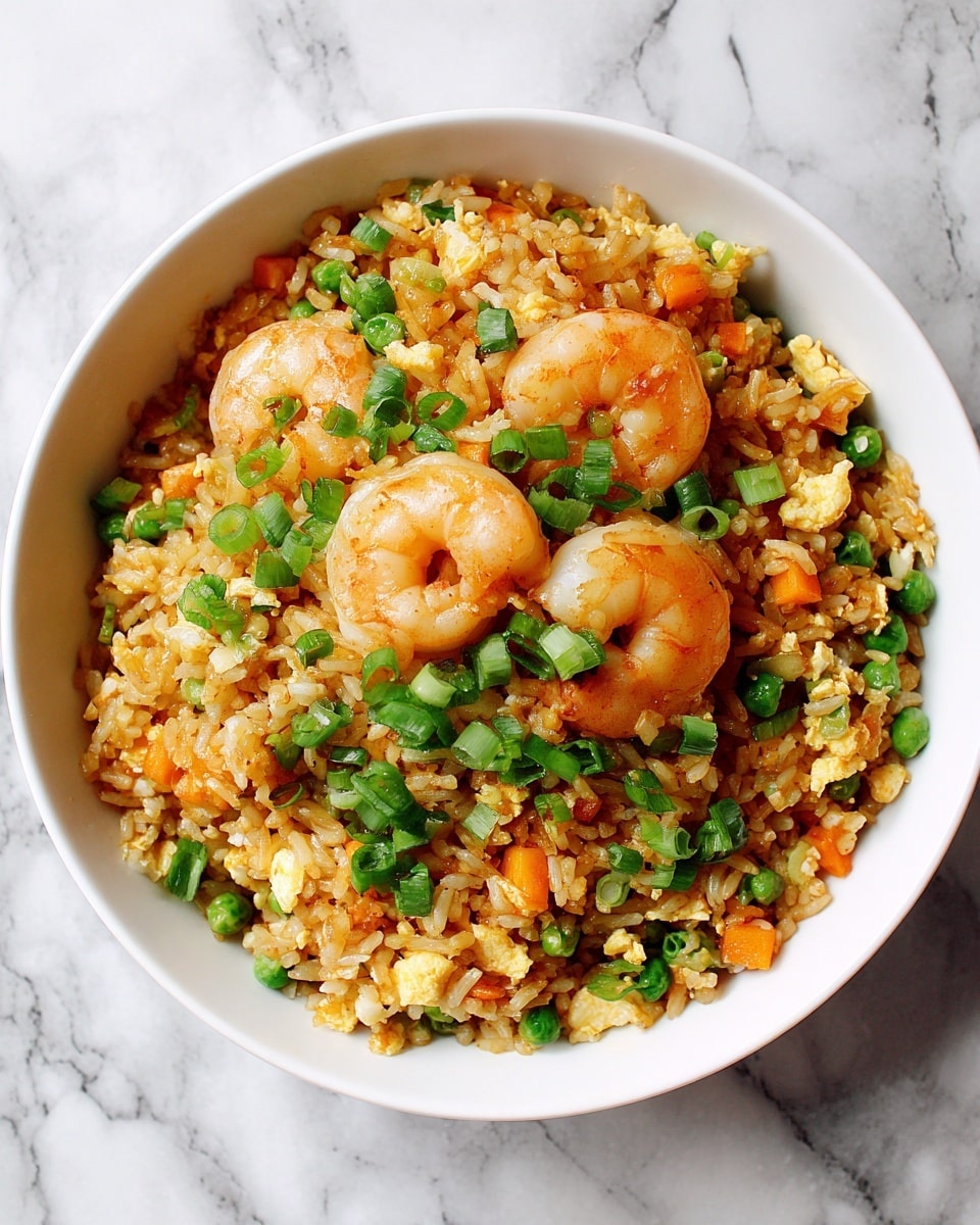 A white bowl filled with fried rice, showing layers of orange shrimp scattered on top and mixed within the grains, small pieces of green peas and diced orange carrots spread evenly throughout, bright green chopped scallions sprinkled over the dish, the rice appearing golden brown with a slightly oily texture, all set against a white marbled surface. photo taken with an iphone --ar 4:5 --v 7