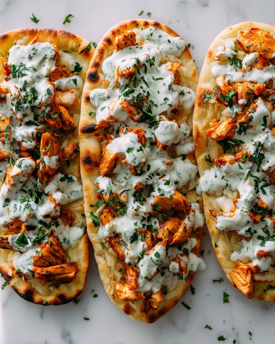 Three flatbreads are placed side by side on a white marbled surface, each topped with layers starting from the bottom with soft, golden-brown flatbread, followed by pieces of grilled, reddish-orange chicken scattered evenly. On top of the chicken, there is a thick drizzle of white sauce mixed with green herbs, creating a creamy and chunky texture. Fresh green chopped herbs are sprinkled over everything, adding a fresh color contrast. The image is close-up, showing the textures of the bread and toppings clearly. Photo taken with an iphone --ar 4:5 --v 7