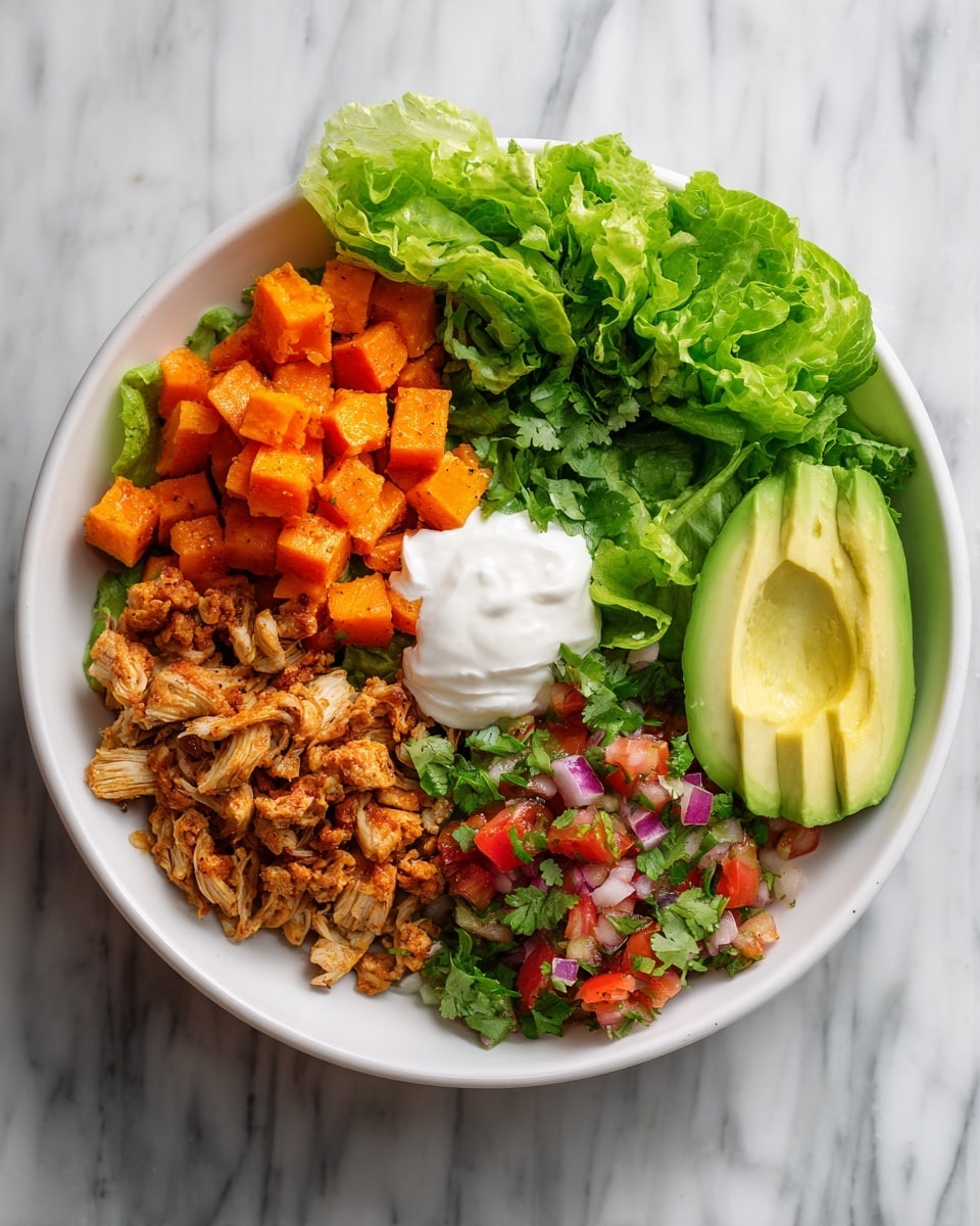 A white bowl is filled with six distinct sections: in the top left, there are small orange cubes of cooked sweet potatoes with a soft texture; next to it on the top right is a fresh green leafy lettuce; in the center top, a dollop of smooth white sour cream sits; to the right of the sour cream, there is a bright green avocado half with a creamy texture; the bottom left shows shredded, seasoned cooked chicken in light brown color with visible grill marks; and the bottom right features a colorful pico de gallo mix with red diced tomatoes, green avocado pieces, purple onion bits, and chopped fresh green cilantro all spread evenly. The bowl sits on a white marbled surface. photo taken with an iphone --ar 4:5 --v 7