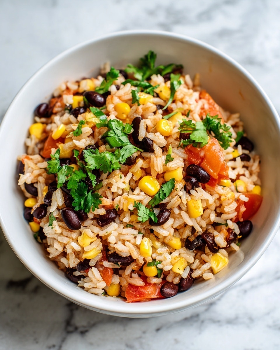 A close-up of a bowl filled with a colorful mix of cooked rice, black beans, corn kernels, and small pieces of red bell pepper. The rice grains are light brown and soft, mixed evenly with dark black beans and bright yellow corn. Green cilantro leaves are scattered on top, adding a fresh look. The bowl is white and sits on a white marbled surface. Photo taken with an iphone --ar 4:5 --v 7